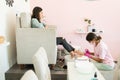 Female Pedicurist Giving Pedicure Services To Client In Salon Royalty Free Stock Photo