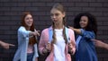 Female peers pointing fingers desperate schoolgirl, college teasing condemnation