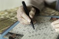 Female pensioner doing crosswords