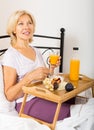 Female pensioner having breakfast Royalty Free Stock Photo