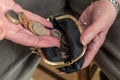 Female pensioner putting money into her purse. Royalty Free Stock Photo