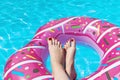 Female with perfect red pedicure over a pool. Vacation pericure. Female with bare feet over blue swimming pool water Royalty Free Stock Photo