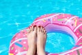 Female with perfect red pedicure over a pool. Vacation pericure. Female with bare feet over blue swimming pool water Royalty Free Stock Photo