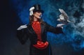 Female perfomer dressed in classic retro clothing posing with doves