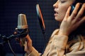 Female performer at micriphone, recording studio Royalty Free Stock Photo