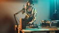 Female performer using mixing turntables and buttons