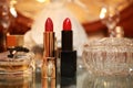 Female perfume and two lipsticks