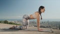 Yoga trainer doing cat pose at city. Woman performing yoga poses outdoors Royalty Free Stock Photo