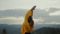 Female person doing warrior yoga pose. Fitness woman performing yoga outdoor