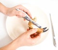 Female person eating crab claw over plate Royalty Free Stock Photo