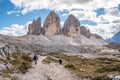 A female person hiking lonely with her dog around the Drei Zinnen mountains, the Dolomites in South Tirol