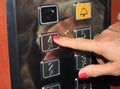 Female person pushing elevator button Royalty Free Stock Photo