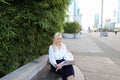 Lady reading newspaper outdoors in with close up face. Royalty Free Stock Photo