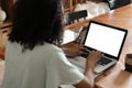 Female person sitting front open laptop computer and smart phone with blank empty screen for your information or content Royalty Free Stock Photo