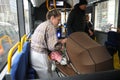 Female person transportin baby pram with public bus transport