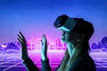 Female person using Virtual reality headset in metaverse universe. Experiencing virtual reality internet metaverse