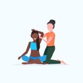 Female personal trainer doing stretching exercises with african american girl fitness instructor helping woman to Royalty Free Stock Photo
