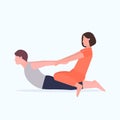 Female personal trainer doing stretching exercises with man fitness instructor helping guy to stretch muscles workout Royalty Free Stock Photo