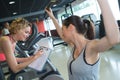 Female personal trainer helping woman in training