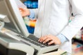 Female pharmacist at the cashier in pharmacy Royalty Free Stock Photo