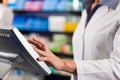 Female pharmacist at the cashier in pharmacy Royalty Free Stock Photo