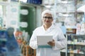 Female pharmacist checking stock inventory in pharmacy. Royalty Free Stock Photo