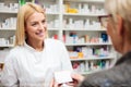 Female pharmacist explaining therapy details to senior female patient Royalty Free Stock Photo