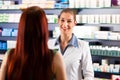 Female pharmacist in her pharmacy with a client Royalty Free Stock Photo