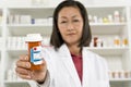 Female Pharmacist Holding Prescription Drugs