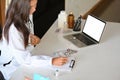 Female pharmacist taking notes and writing prescriptions on medical clipboard Royalty Free Stock Photo