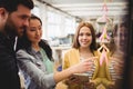 Female photo editor standing near coworkers pointing on sticky note Royalty Free Stock Photo