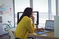 Female photo editor using laptop in creative office Royalty Free Stock Photo