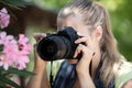 female photograph with camera taking macro picture flower