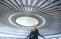 A female photographer admiring a huge circular concert hall ceiling