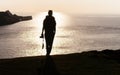 Female photographer backpacker silhouette front shot on top of m