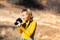 Female photographer capturing autumn scenes