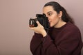 Female photographer focusing on the viewer