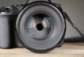 Female photographer holding professional camera on table Royalty Free Stock Photo