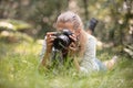 female photographer laying on grass Royalty Free Stock Photo