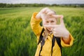 Female photographer making frame with her hands outdoors Royalty Free Stock Photo