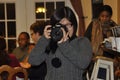 A female photographer takes pictures during a event Royalty Free Stock Photo