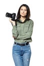 Female photographer reporter in jeans and a khaki shirt posing with a camera. Isolated on white