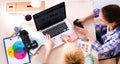 Female photographer sitting on the desk with laptop Royalty Free Stock Photo