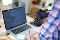 Female photographer sitting on the desk with