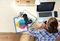 Female photographer sitting on the desk with laptop Royalty Free Stock Photo