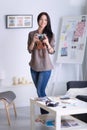 Female photographer sitting on the desk with laptop . Female photographer