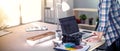 Female photographer sitting on the desk with laptop . Female photographer Royalty Free Stock Photo