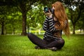 Female photographer sitting on grass Royalty Free Stock Photo