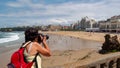 Female photographer taking a photograph of the Biarritz city