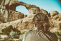 Female photographer taking picture of Skyline Arch in Arches Nat Royalty Free Stock Photo